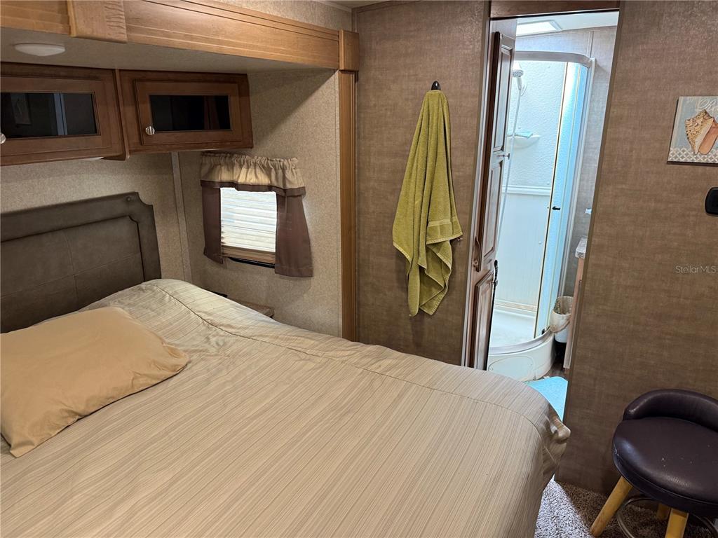 2875 Northeast 102nd Ave Road Silver Springs, FL 34488 - Photo 24 of 68 a bedroom with a bed a flat screen tv and a dresser