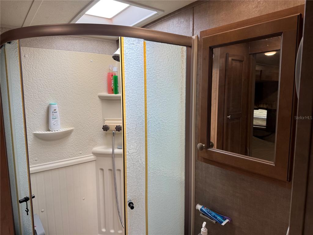 2875 Northeast 102nd Ave Road Silver Springs, FL 34488 - Photo 25 of 68 a bathroom with a shower and a sink