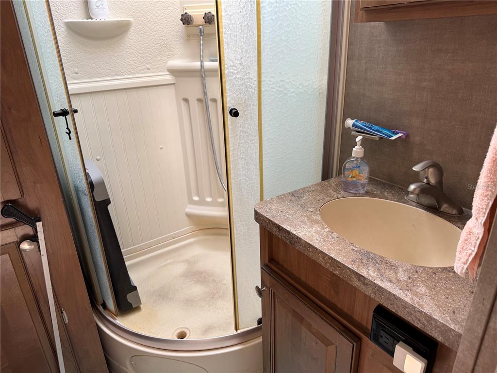 2875 Northeast 102nd Ave Road Silver Springs, FL 34488 - Photo 26 of 68 a bathroom with a granite countertop sink and a mirror