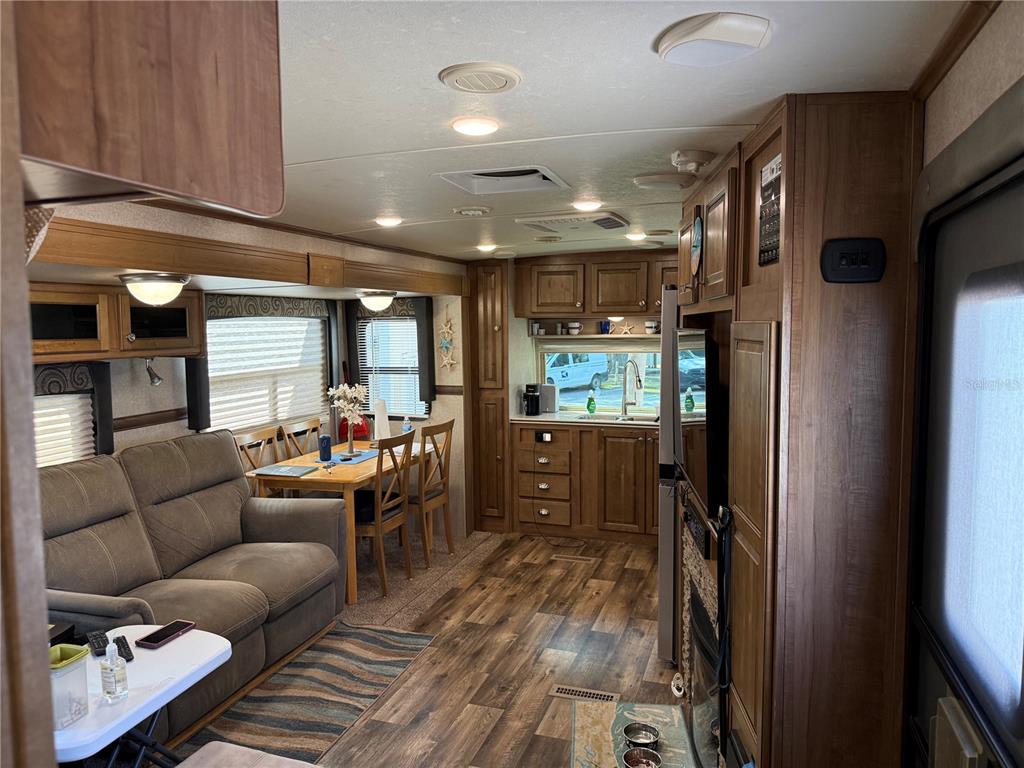 2875 Northeast 102nd Ave Road Silver Springs, FL 34488 - Photo 28 of 68 a living room with furniture and a walk in closet