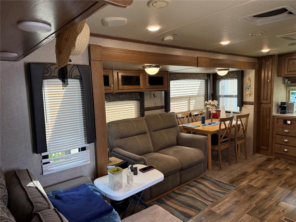 2875 Northeast 102nd Ave Road Silver Springs, FL 34488 - Photo 29 of 68 a living room with furniture and wooden floor