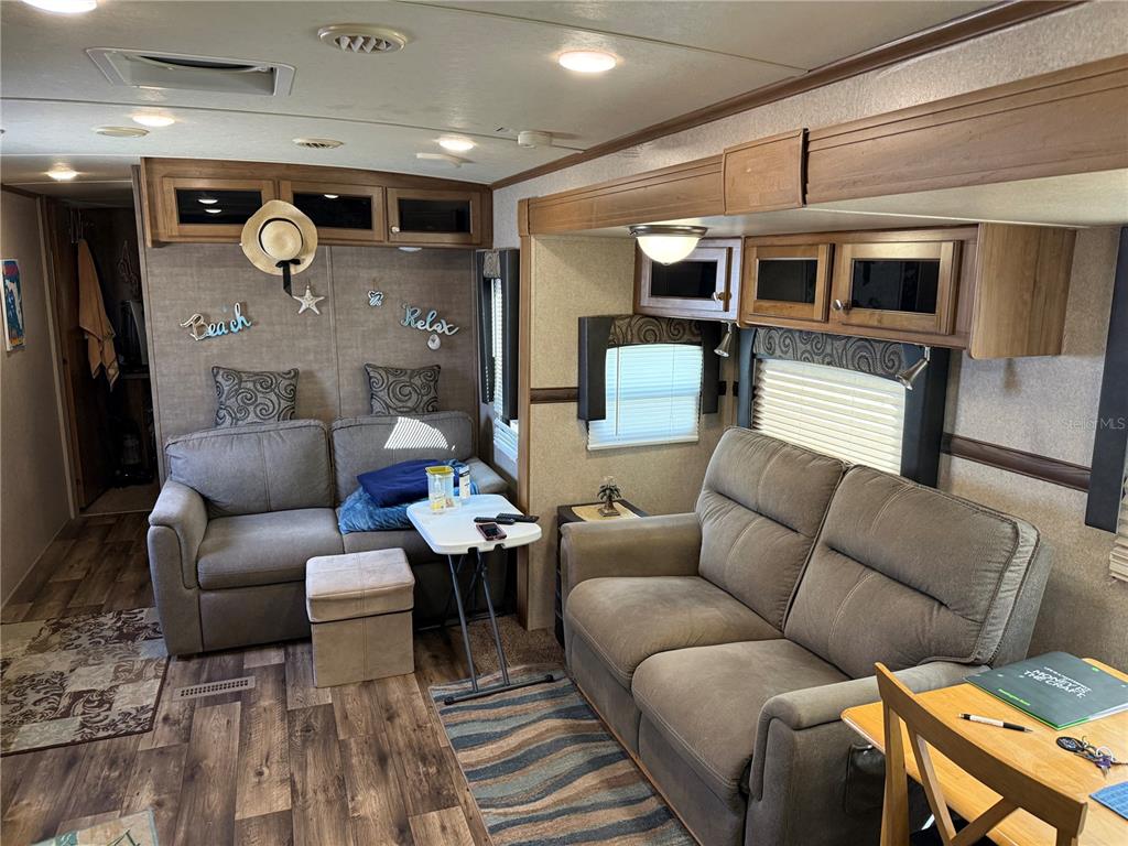 2875 Northeast 102nd Ave Road Silver Springs, FL 34488 - Photo 31 of 68 a living room with furniture a rug and kitchen view