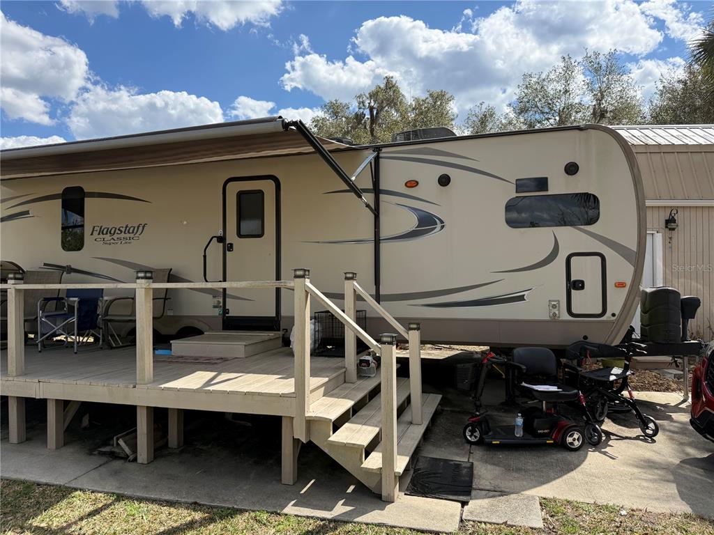 2875 Northeast 102nd Ave Road Silver Springs, FL 34488 - Photo 5 of 68 a roof deck with table and chairs