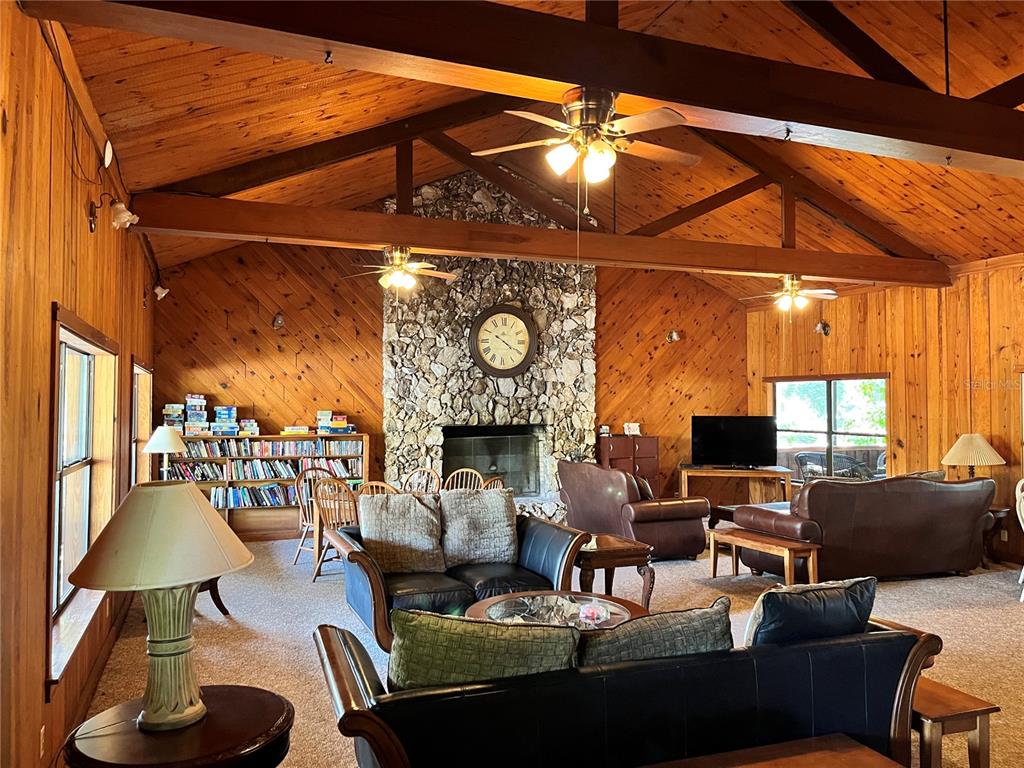 2875 Northeast 102nd Ave Road Silver Springs, FL 34488 - Photo 62 of 68 a living room with furniture a lamp and a large window