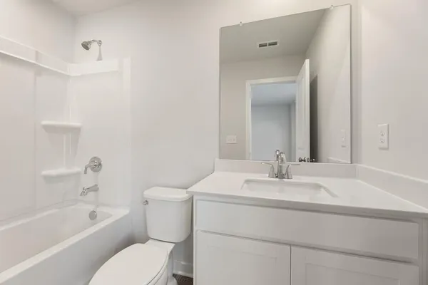 a bathroom with a sink toilet vanity and tub