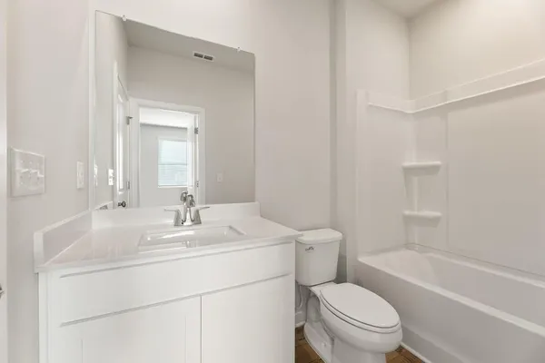 a bathroom with a sink toilet vanity tub and shower