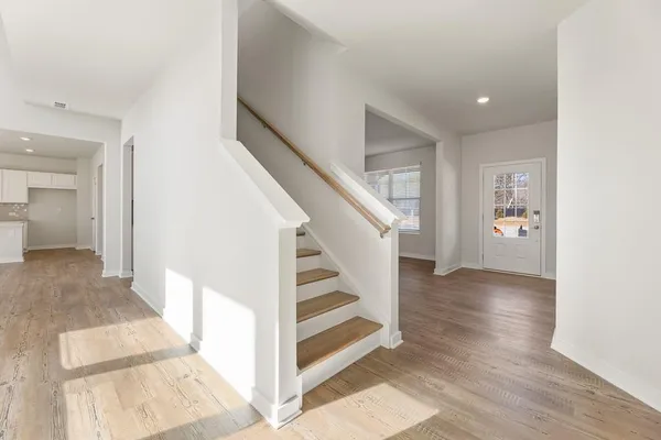 a view of a hallway view with wooden floor and staircase