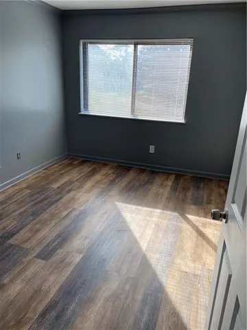 a view of wooden floor and windows in a room