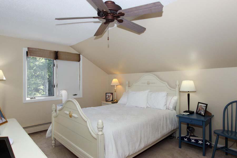 136 West Way Mashpee, MA 02649 - Photo 14 of 30 a bedroom with a bed and a chandelier