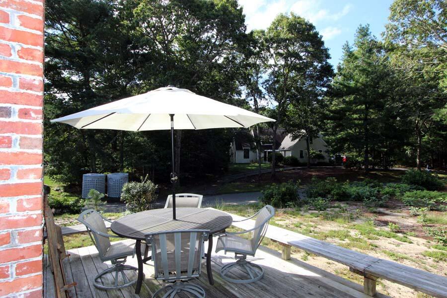 136 West Way Mashpee, MA 02649 - Photo 4 of 30 a backyard of a house with table and chairs