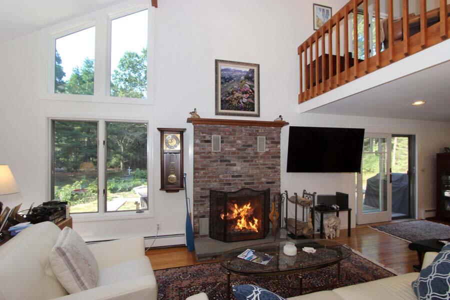 136 West Way Mashpee, MA 02649 - Photo 8 of 30 a living room with furniture a fireplace and a flat screen tv