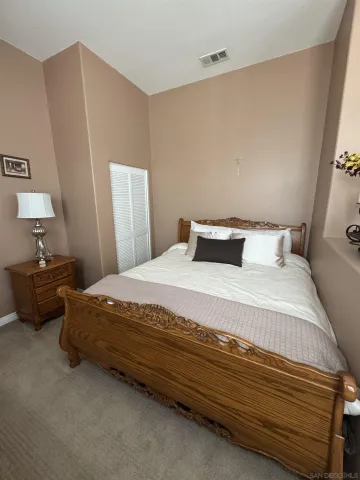 a bedroom with a bed and a lamp