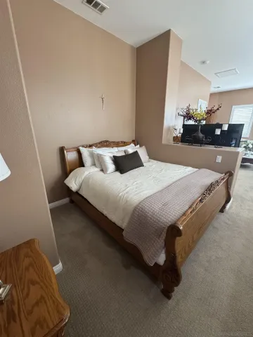 a bedroom with bed and window