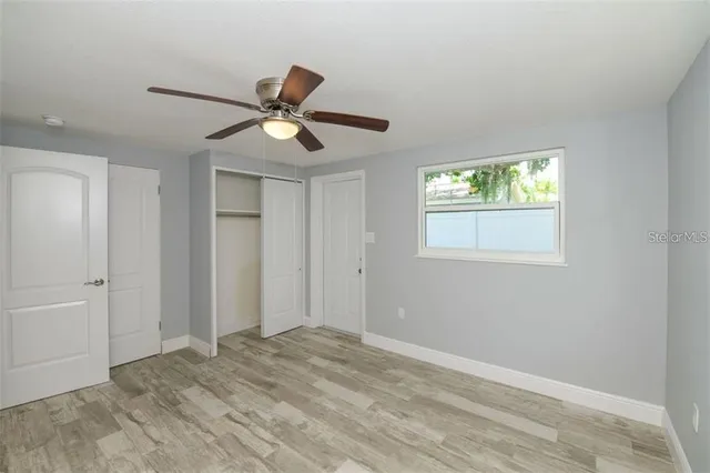 a view of a livingroom with a ceiling fan and window