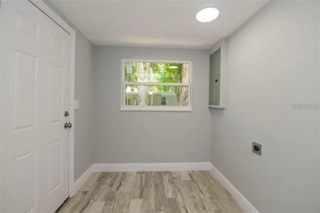 wooden floor in an empty room with a window