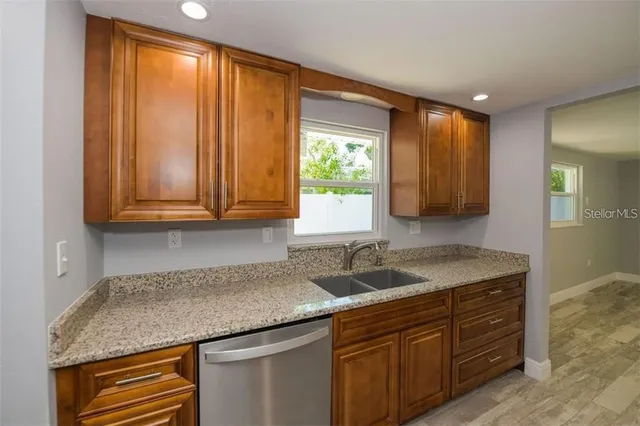 a kitchen with a sink and a window