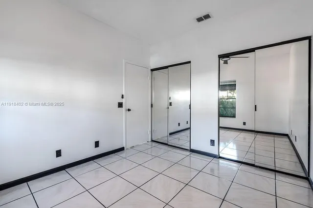 a view of a refrigerator and window in a room