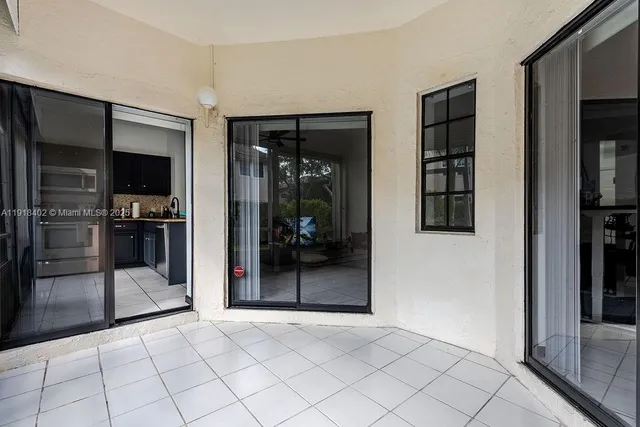 a view of empty room with window and refrigerator
