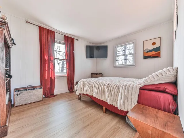 a bedroom with furniture and a window