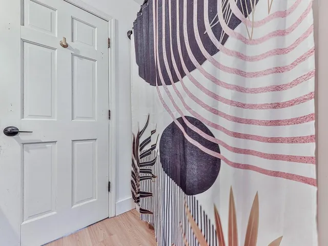 a view of gym equipment with wooden floor