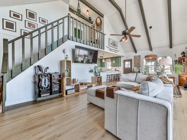 a living room with furniture and wooden floor
