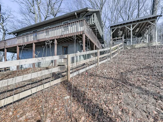 a living room with furniture a fireplace and large windows