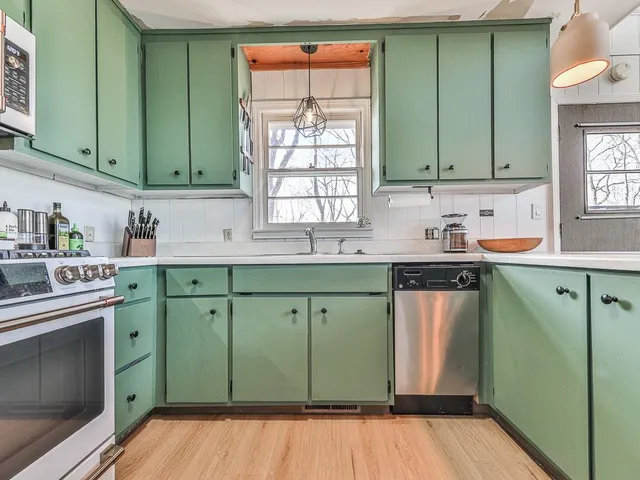 a kitchen with a sink cabinets and a microwave oven
