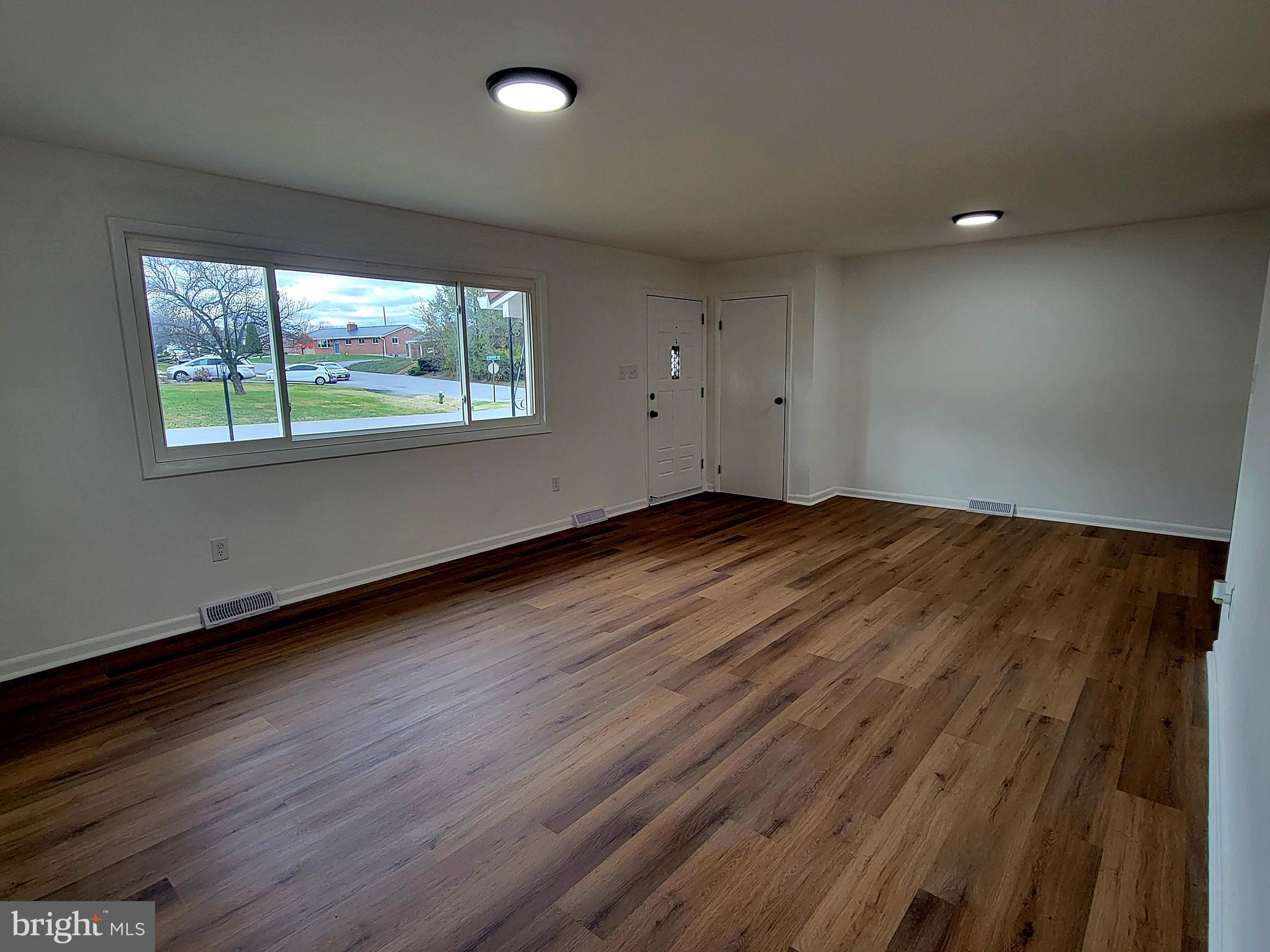 11525 Englewood Road Hagerstown, MD 21740 - Photo 4 of 21 an empty room with wooden floor and windows