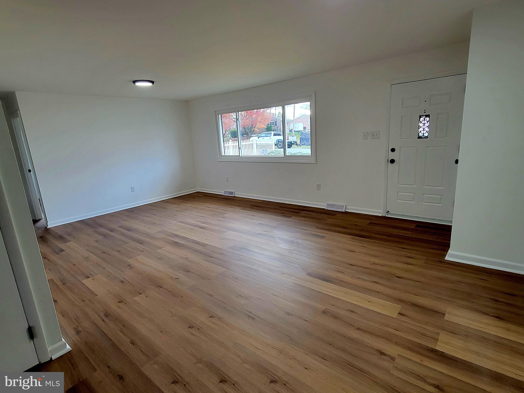 11525 Englewood Road Hagerstown, MD 21740 - Photo 5 of 21 a view of an empty room with wooden floor and a window