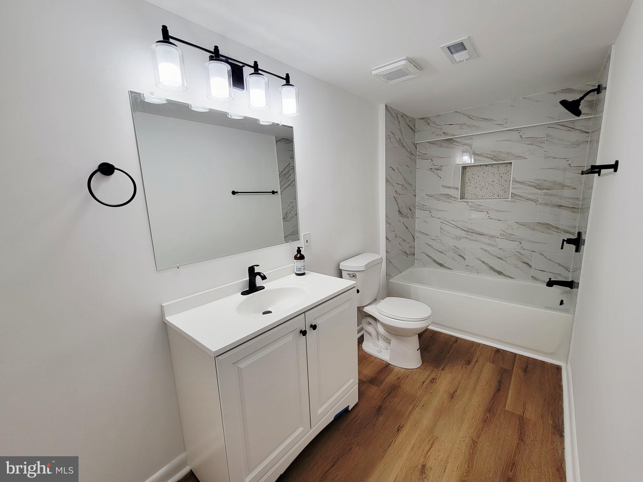 11525 Englewood Road Hagerstown, MD 21740 - Photo 6 of 21 a bathroom with a sink a toilet and shower