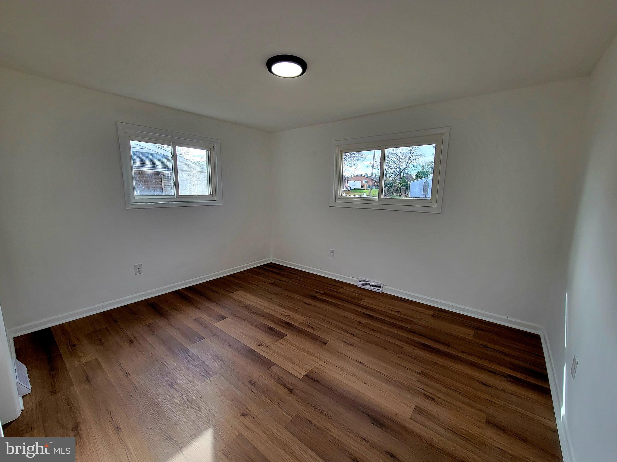 11525 Englewood Road Hagerstown, MD 21740 - Photo 8 of 21 a view of an empty room with wooden floor and a window