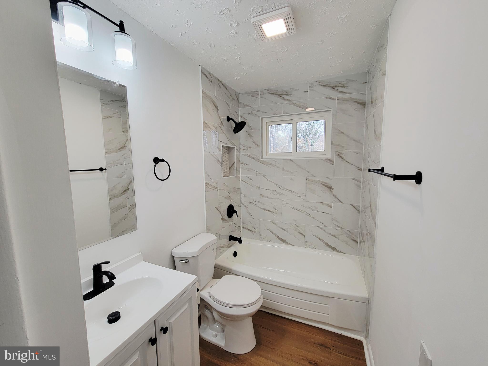 11525 Englewood Road Hagerstown, MD 21740 - Photo 10 of 21 a bathroom with a sink a toilet and shower