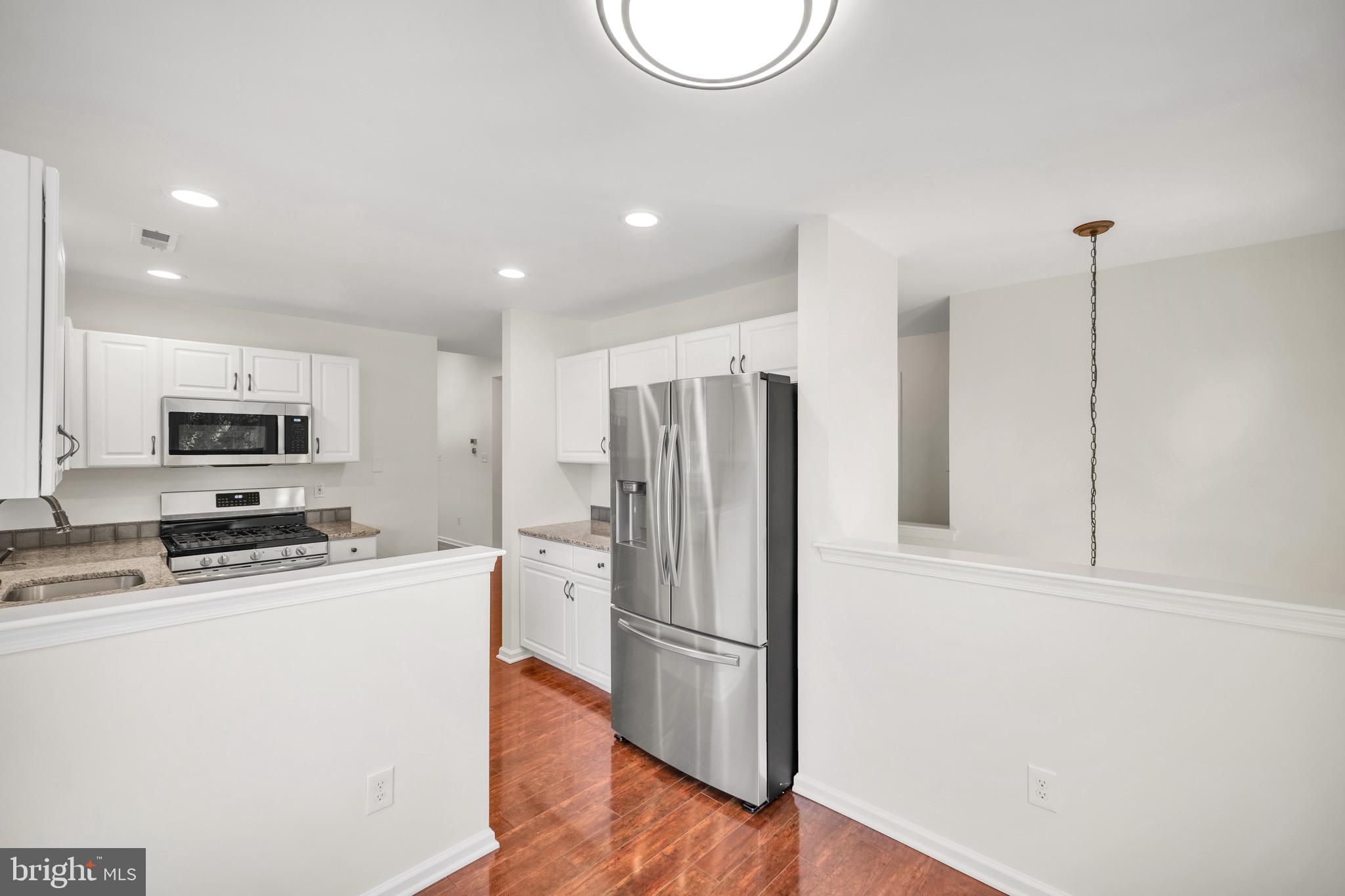 2402 Waterford Road, Unit 94 Yardley, PA 19067 - Photo 6 of 28 a kitchen with stainless steel appliances a refrigerator sink and microwave