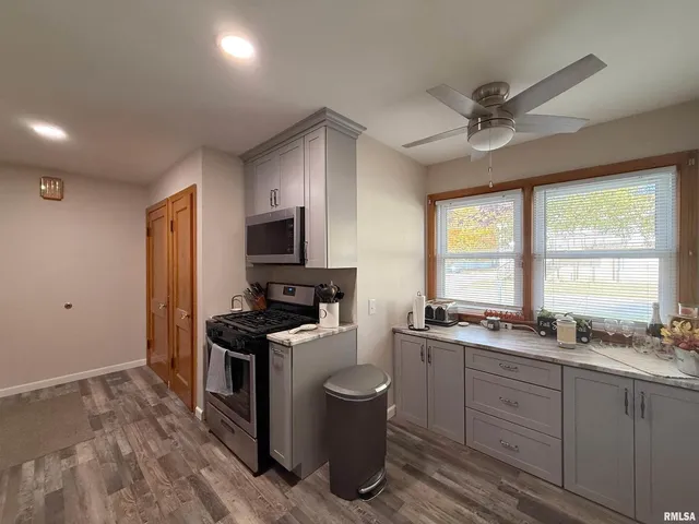 a kitchen with a stove a sink and a refrigerator