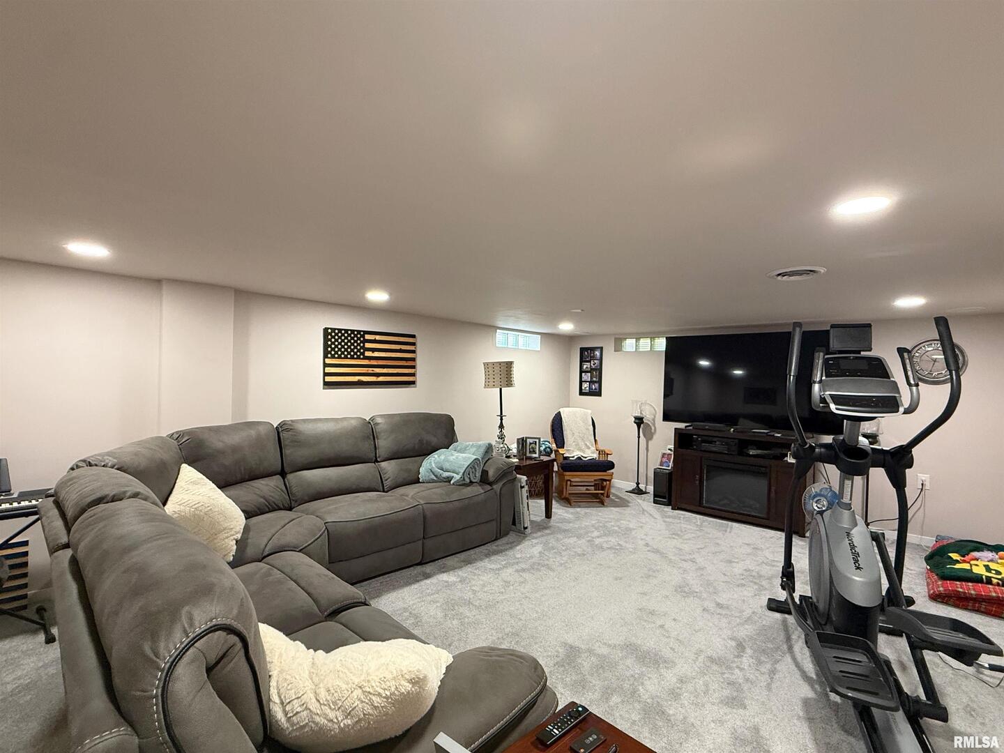 640 32nd Avenue Moline, IL 61265 - Photo 24 of 37 a living room with furniture a flat screen tv and gym equipment