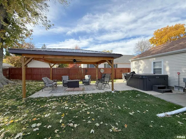 a view of a house with backyard porch and sitting area