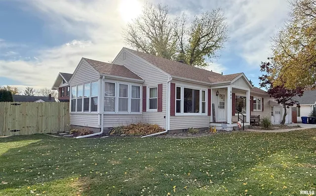 a house that has a big yard with plants and trees