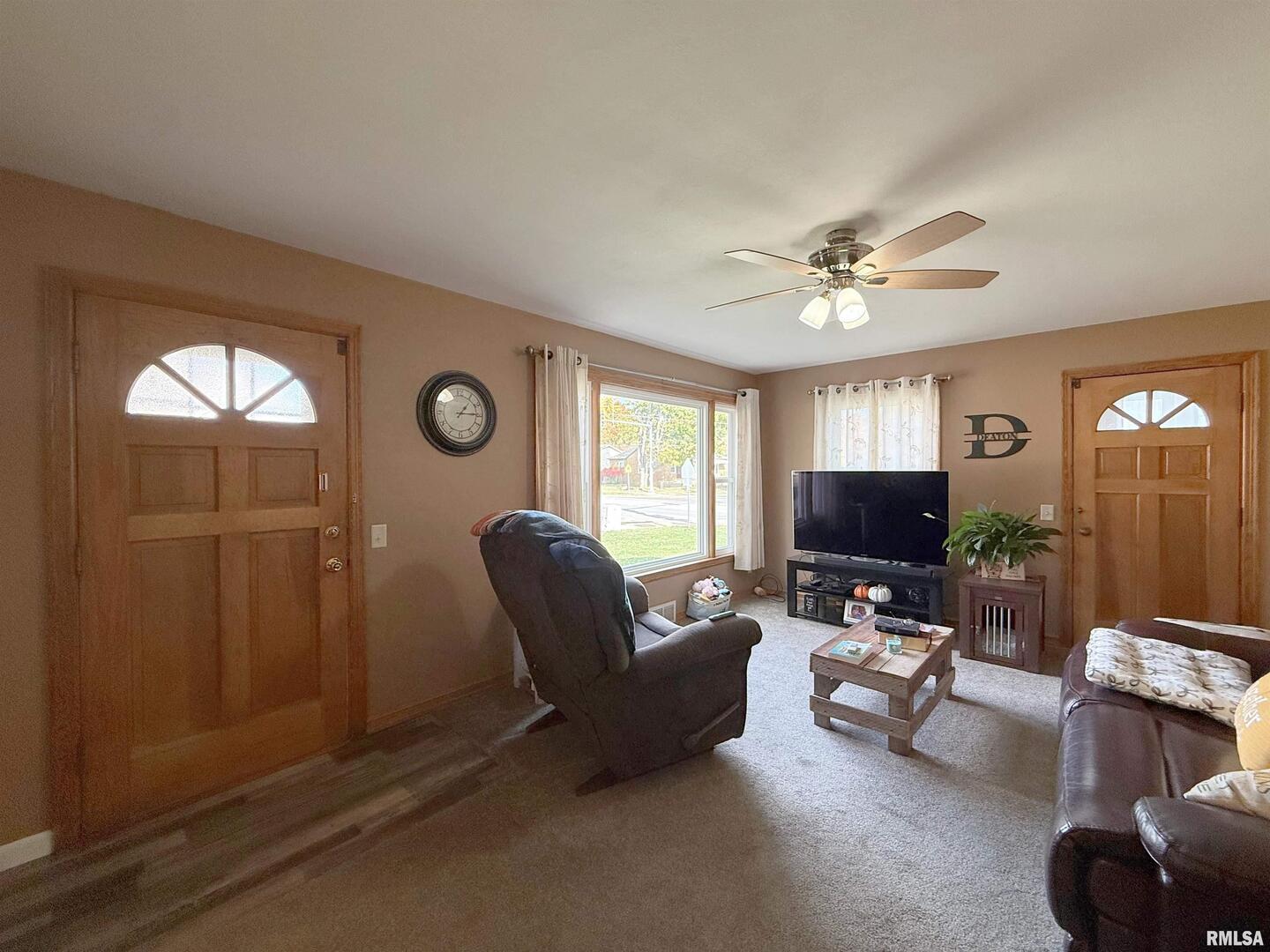 640 32nd Avenue Moline, IL 61265 - Photo 7 of 37 a living room with furniture a ceiling fan and a window