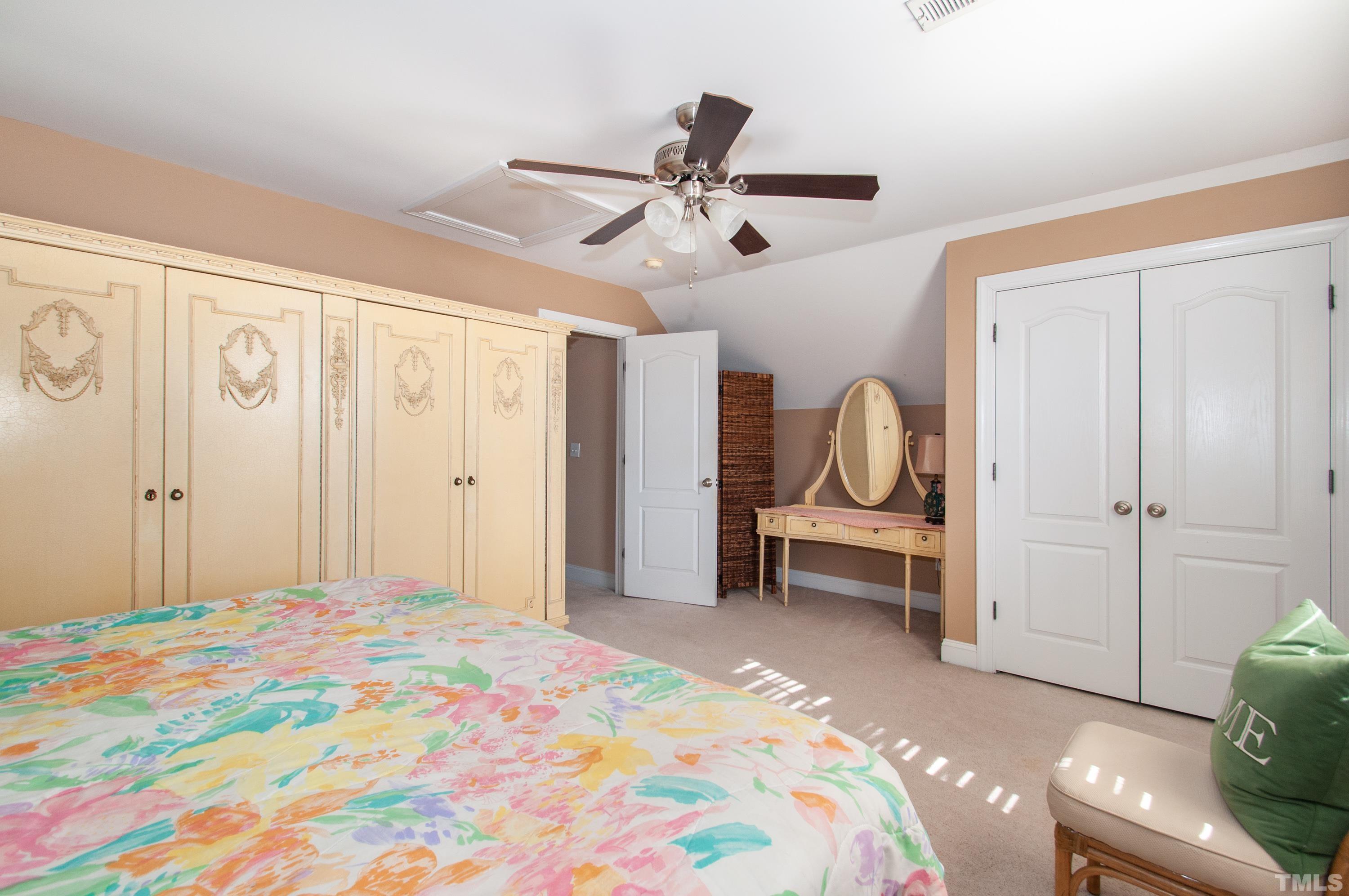 5012 Contender Drive Raleigh, NC 27603 - Photo 15 of 27 a bedroom with a bed and a chandelier