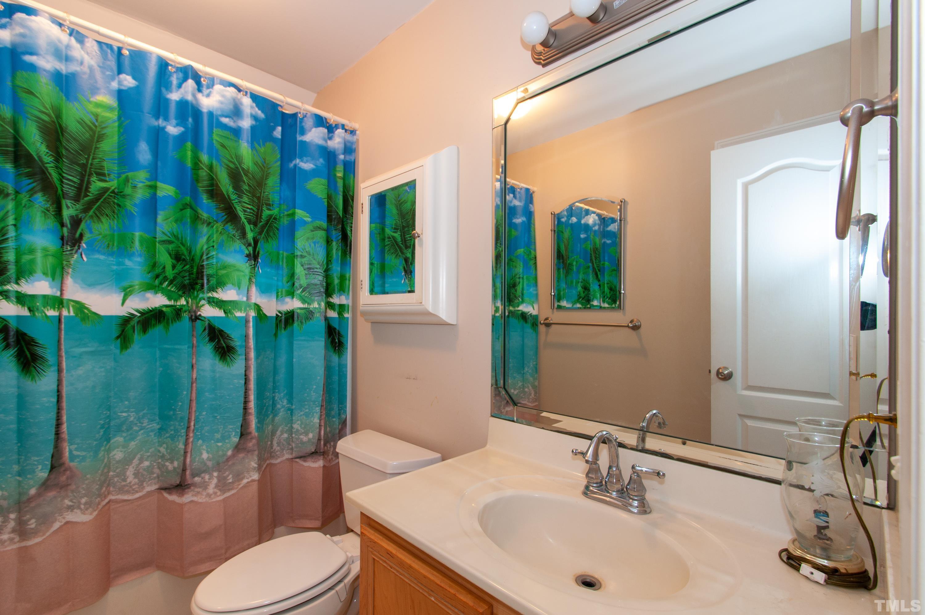 5012 Contender Drive Raleigh, NC 27603 - Photo 20 of 27 a bathroom with a sink toilet and shower