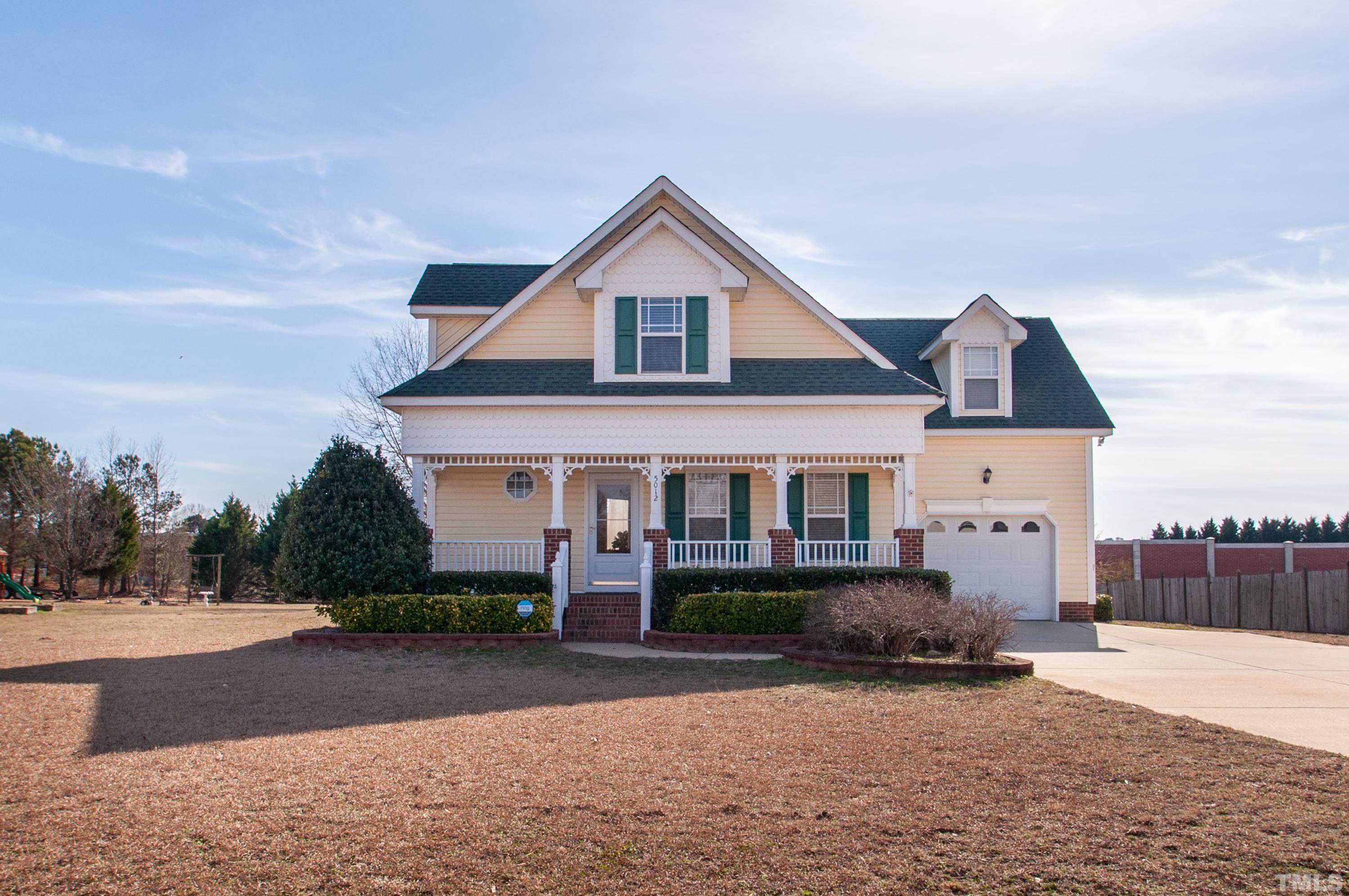 5012 Contender Drive Raleigh, NC 27603 - Photo 2 of 27 a front view of a house with a yard and garage