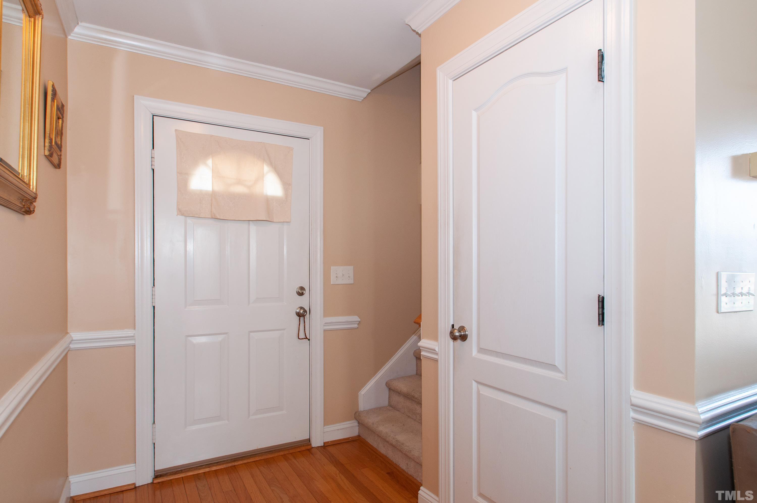 5012 Contender Drive Raleigh, NC 27603 - Photo 3 of 27 a view of a hallway with wooden floor and closet area
