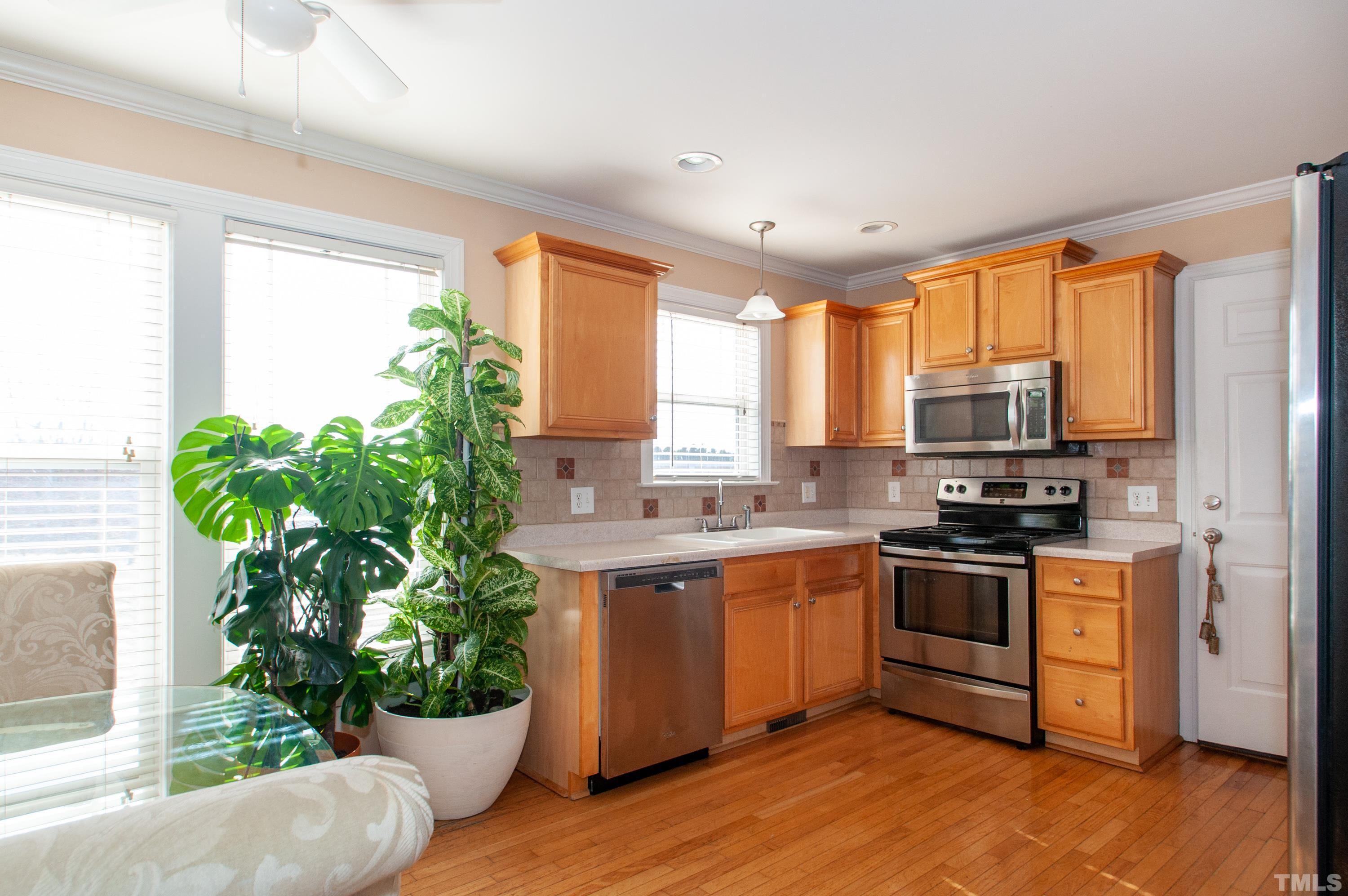 5012 Contender Drive Raleigh, NC 27603 - Photo 6 of 27 a kitchen with a sink stove and cabinets