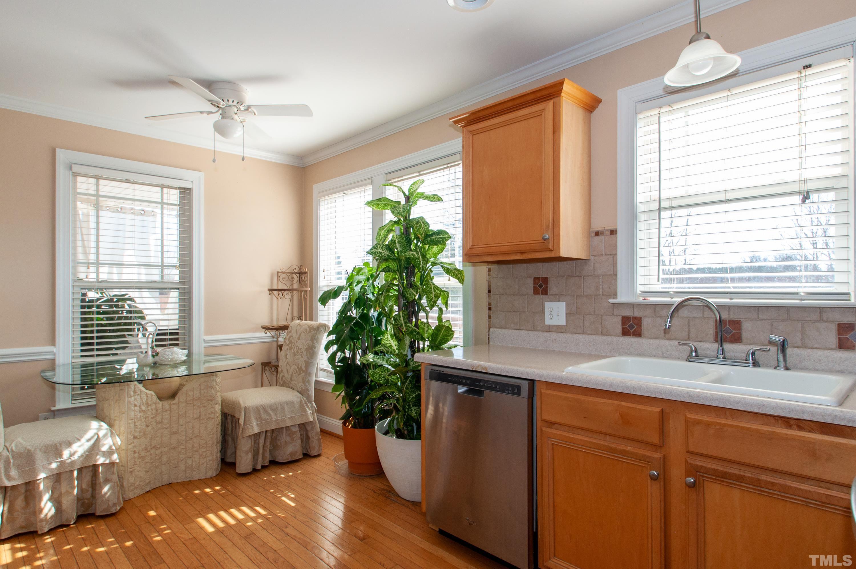 5012 Contender Drive Raleigh, NC 27603 - Photo 8 of 27 a kitchen with stainless steel appliances granite countertop a sink a counter space and a window
