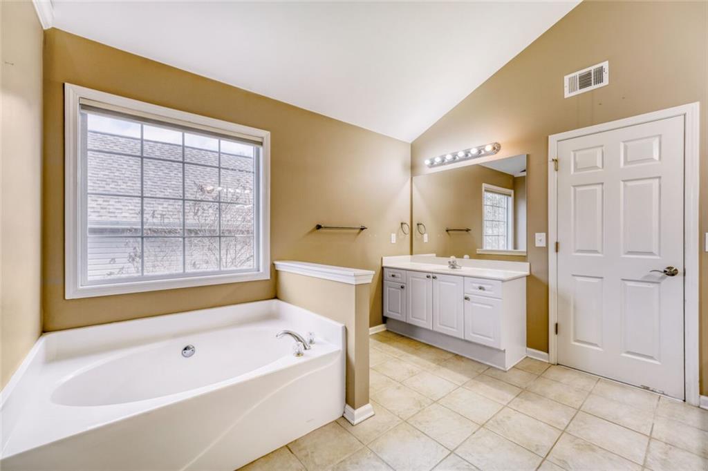2531 Apalachee Run Way Dacula, GA 30019 - Photo 19 of 29 a spacious bathroom with a tub sink and mirror