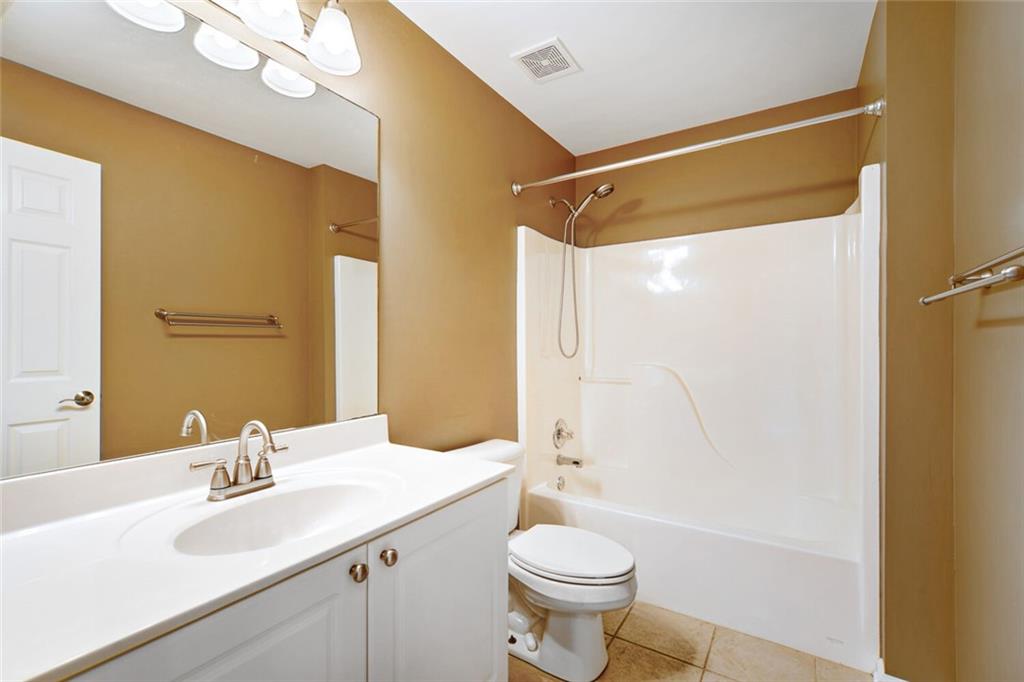 2531 Apalachee Run Way Dacula, GA 30019 - Photo 24 of 29 a bathroom with a sink a toilet and shower