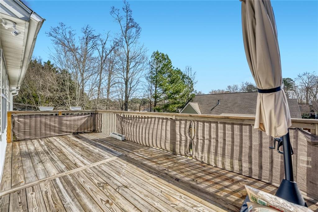 2531 Apalachee Run Way Dacula, GA 30019 - Photo 27 of 29 a view of a balcony with wooden floor and fence
