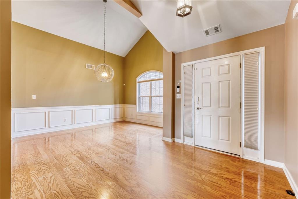 2531 Apalachee Run Way Dacula, GA 30019 - Photo 4 of 29 a view of an empty room with wooden floor and a window