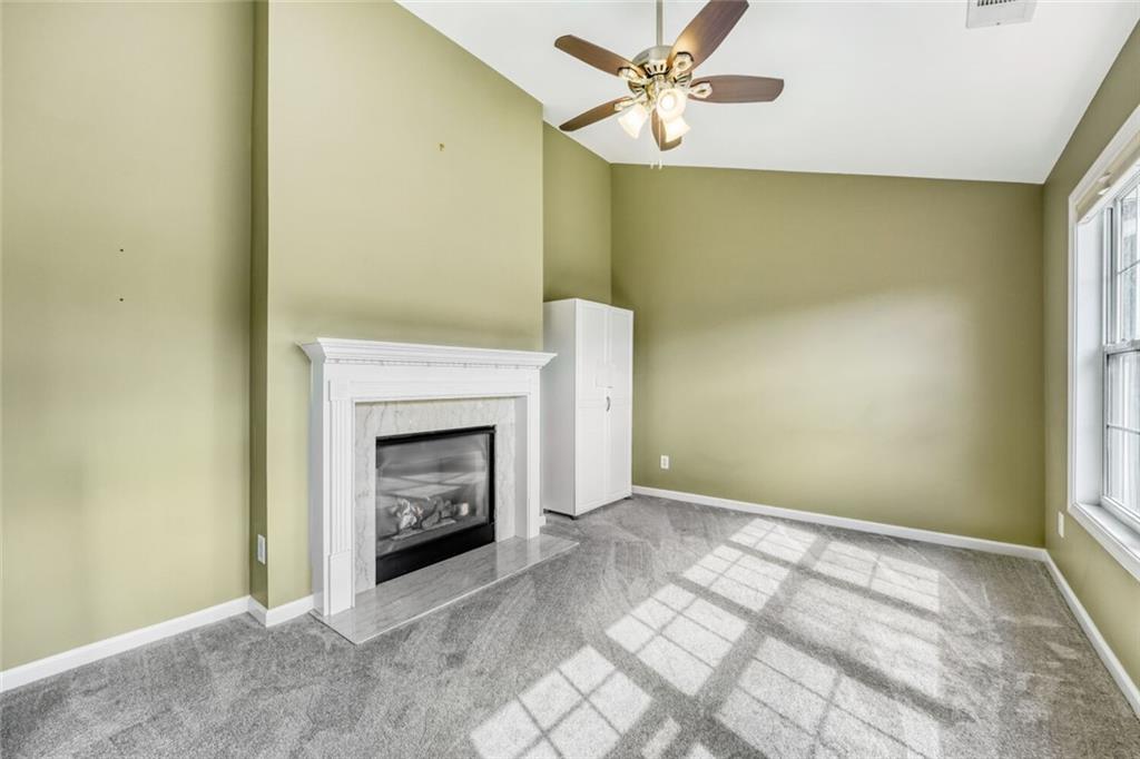 2531 Apalachee Run Way Dacula, GA 30019 - Photo 7 of 29 a view of an empty room with a fireplace