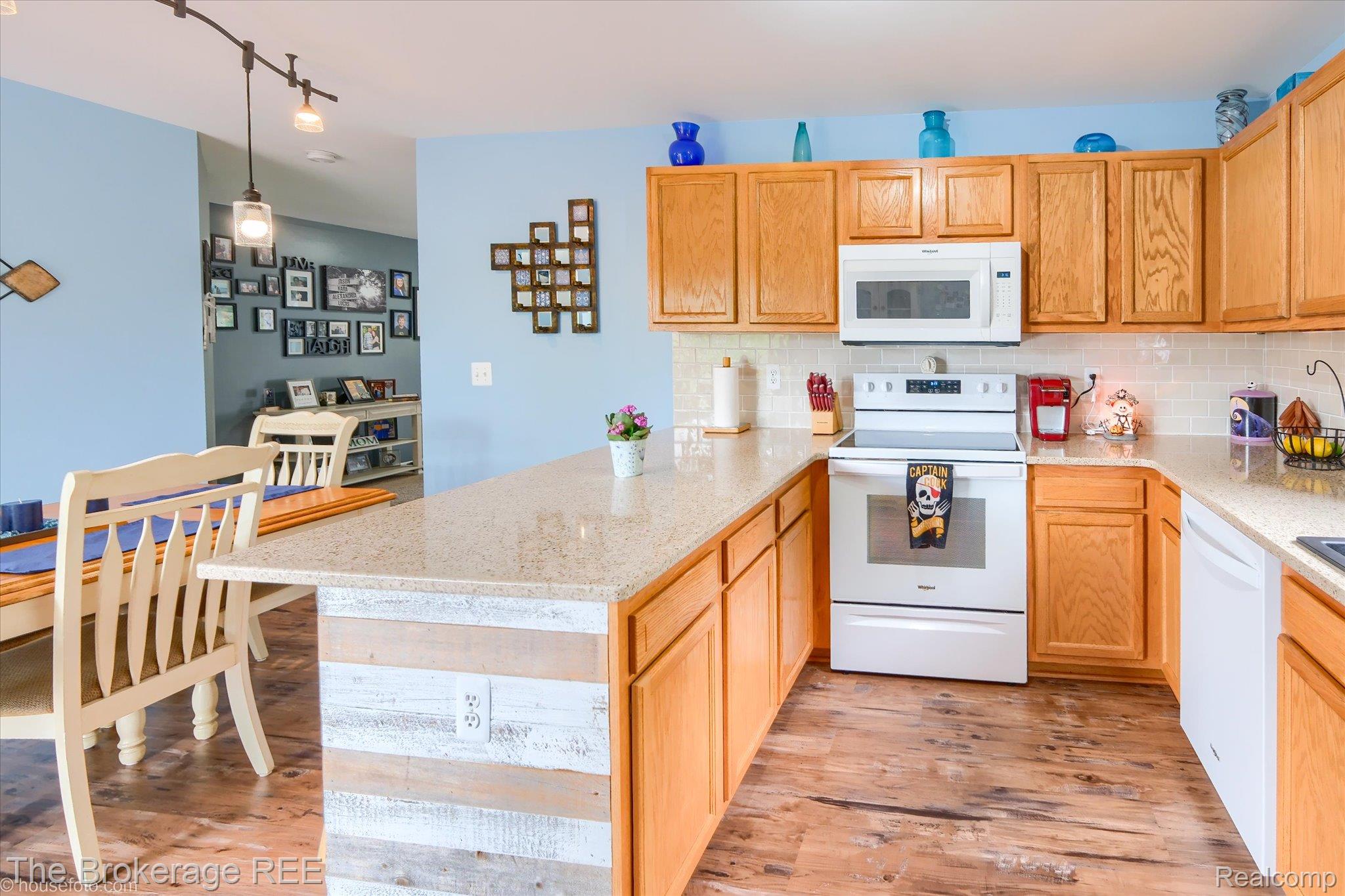 4432 North Belsay Road Flint, MI 48506 - Photo 39 of 79 Kitchen featuring wood cabinetry, white appliances, light-toned countertops, and a subway tile backsplash